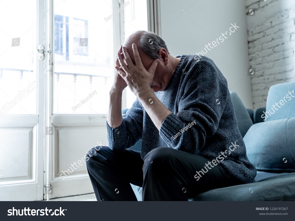 Stock Photo Overwhelmed Old Senior Man Suffering Alone At Home Feeling Confused Sad Alone On Couch At Home In 1226197267